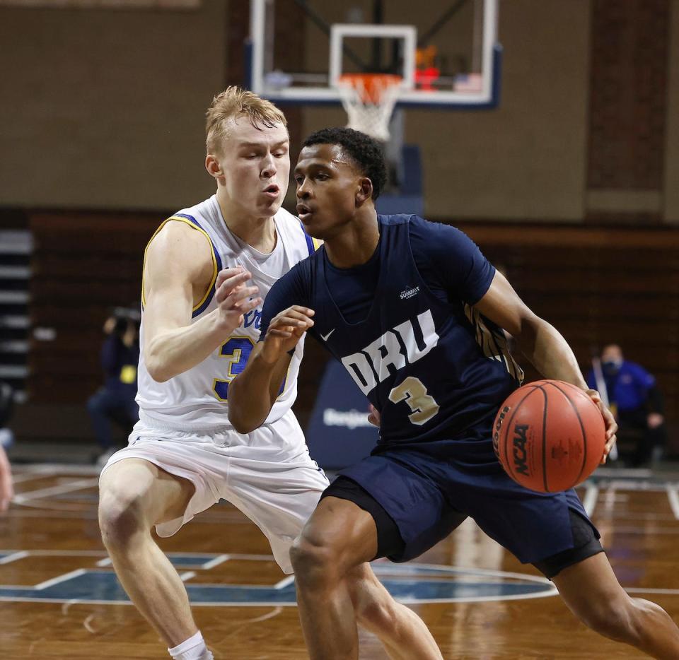 Max Abmas #3 of the Oral Roberts Golden Eagles drives on Charlie Easley #30 of the South Dakota State Jackrabbits during the Summit League Basketball Tournament at the Sanford Pentagon in Sioux Falls, SD.