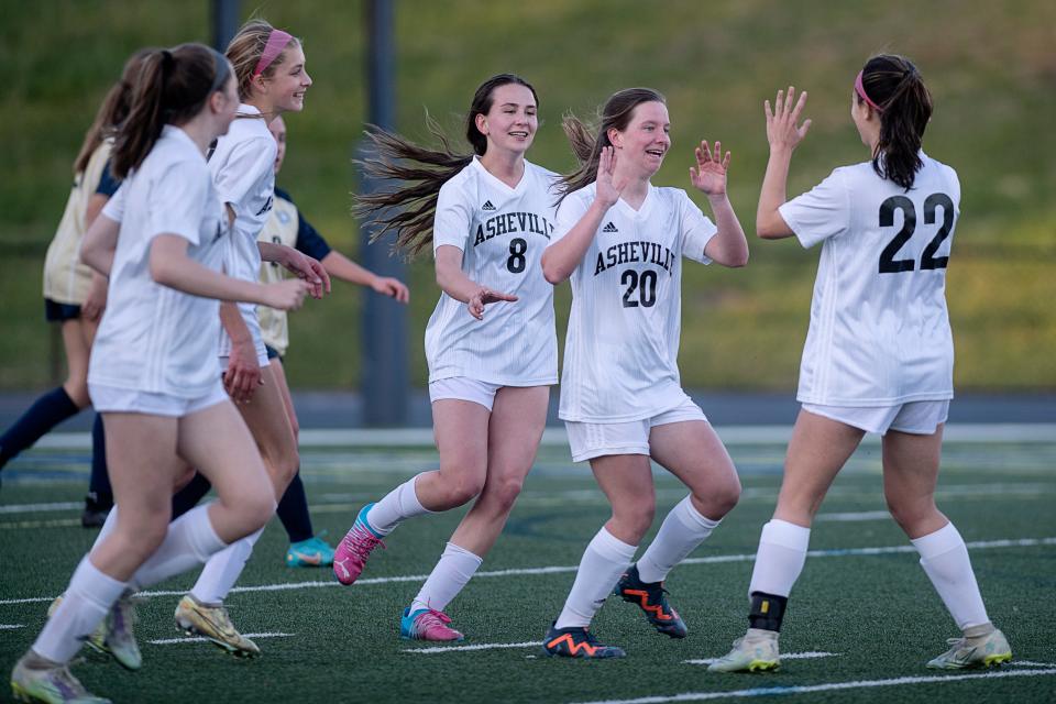 Peyton Case is congratulated by teammates after scoring a goal in the game at Roberson March 29, 2023.