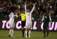 CARSON, CA - APRIL 23: David Beckham #23 of the Los Angeles Galaxy reacts as teammate Sean Franklin #5 receives a yellow card from referee Ramon Hernandez for a foul on Kalif Alhassan #11 of the Portland Timbers in the first half during the MLS match at The Home Depot Center on April 23, 2011 in Carson, California. The Galaxy defeated the Timbers 3-0. (Photo by Victor Decolongon/Getty Images)