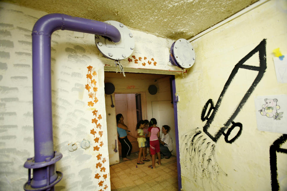 FILE - Israelis gather in a shelter during a rocket attack by Hezbollah guerillas in the northern Israeli town of Kiryat Shmona, Thursday, Aug. 3, 2006. (AP Photo/Oded Balilty, File)