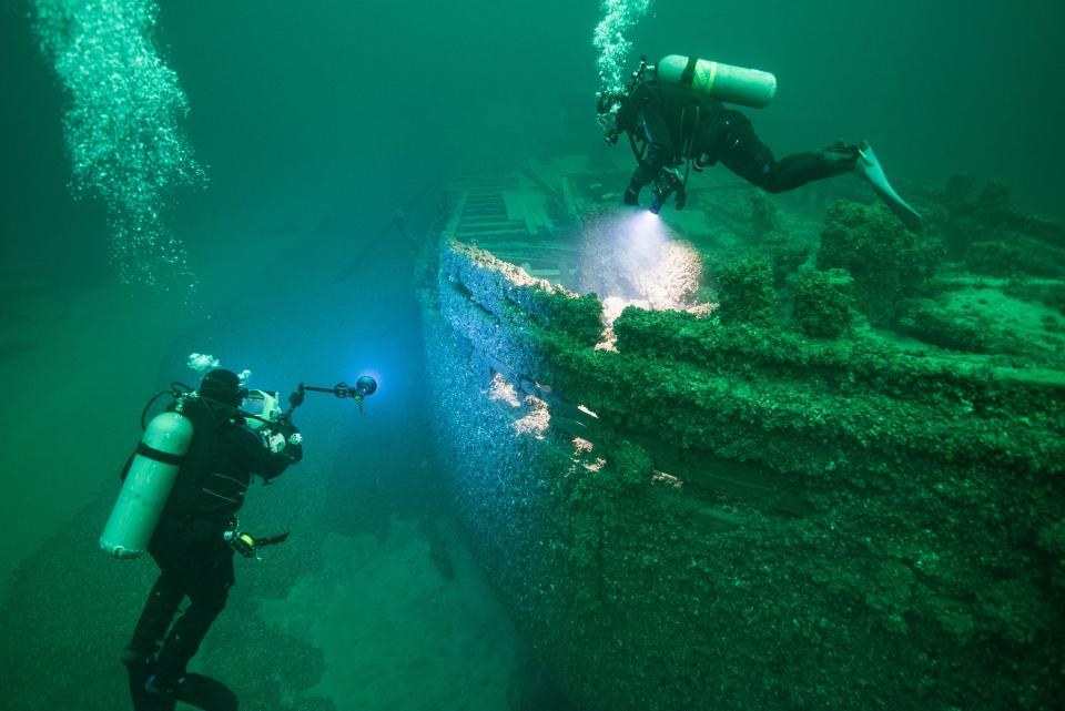 Divers explore the wreck of the St. Peter beneath the waves of Lake Ontario in 2019.