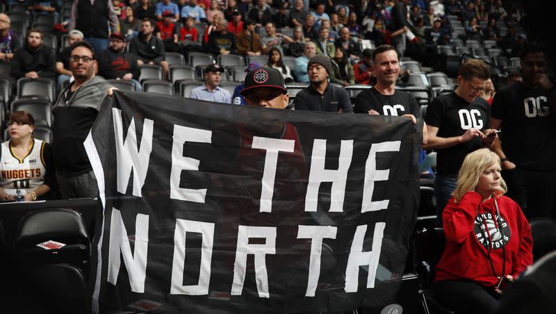 Toronto Raptors fan holds up banner in the first half of an NBA basketball game Sunday, Dec. 16, 2018, in Denver. 