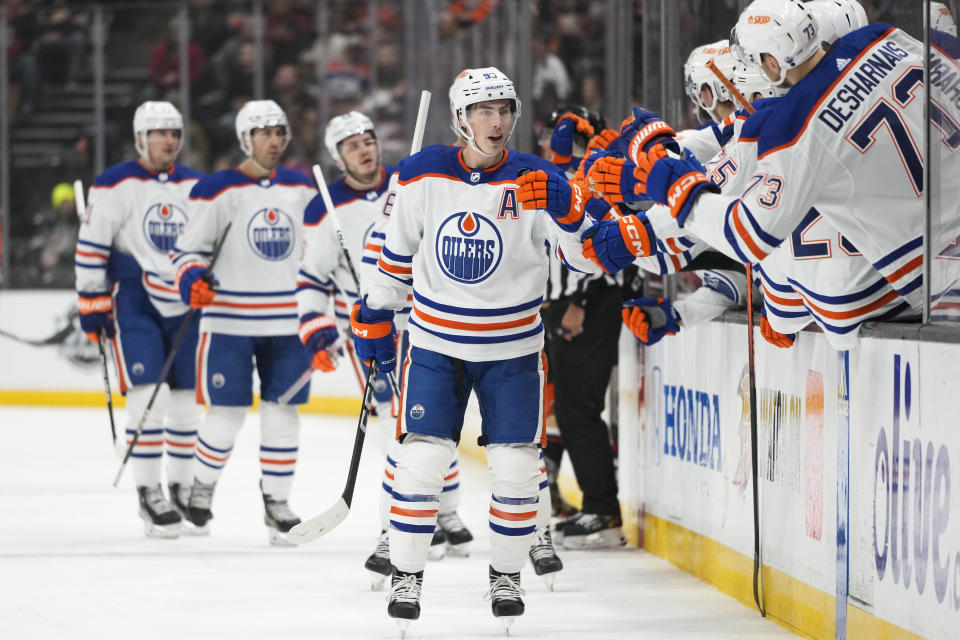 Edmonton Oilers' Ryan Nugent-Hopkins (93) is congratulated for his goal during the first period of the team's NHL hockey game against the Anaheim Ducks on Wednesday, Jan. 11, 2023, in Anaheim, Calif. (AP Photo/Jae C. Hong)