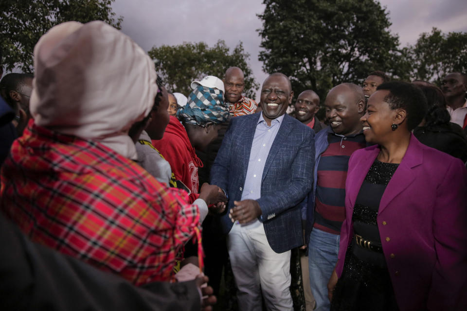 Deputy President and presidential candidate William Ruto, center, greets supporters after casting his vote in Kenya's general election in Sugoi, 50 kms (35 miles) north west of Eldoret, Kenya, Tuesday Aug. 9, 2022. Kenyans are voting to choose between opposition leader Raila Odinga and Ruto to succeed President Uhuru Kenyatta after a decade in power. (AP Photo/Brian Inganga)