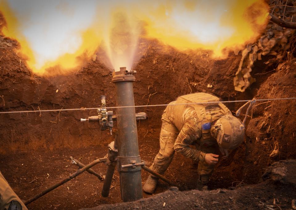 FILE - Ukrainian servicemen with the 28th Separate Mechanized Brigade fire a mortar at Russian forces on the front line near the city of Bakhmut in Ukraine’s Donetsk region, on March 3, 2024. The outgunned and outnumbered Ukrainian troops are struggling to halt Russian advances as a new U.S. aid package is stuck in Congress. (AP Photo/Efrem Lukatsky, File)