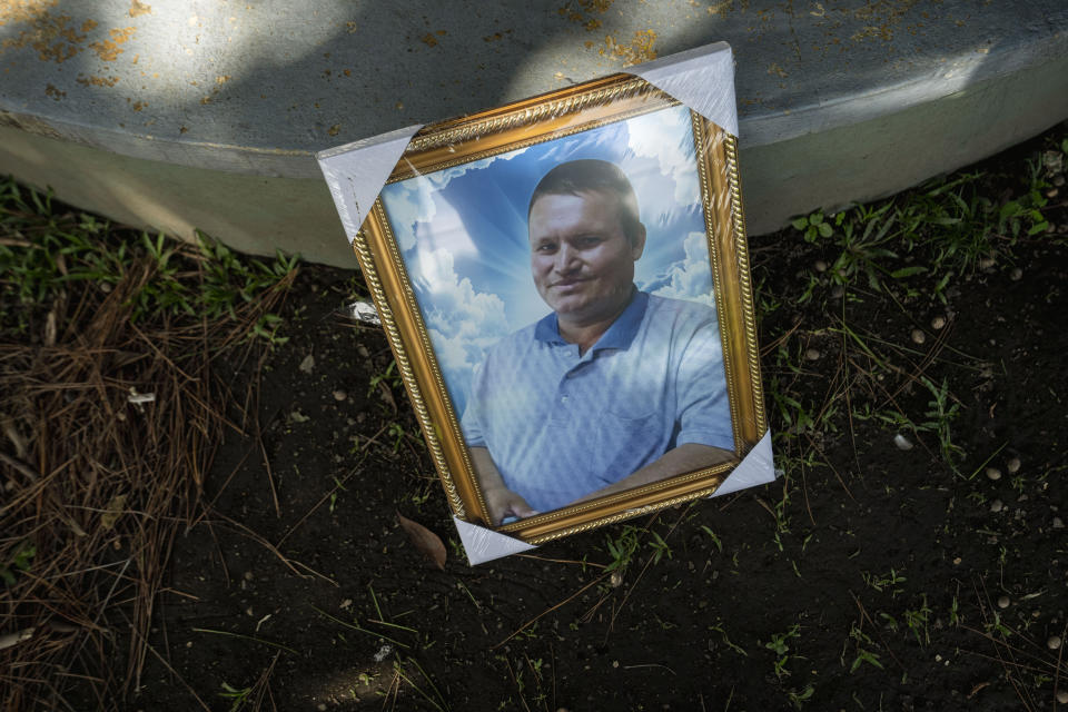 A portrait of Henry Joya, who was arrested under the "state of exception", is propped up against a park bench in San Salvador, El Salvador, Wednesday, Oct. 12, 2022. Jesus Joya says his brother Henry was “special” -- at 45, he was childlike, eager to please. He was as far from a gang member as anyone could be. And yet the last time he saw Henry, he was boarding a bus to prison. (AP Photo/Moises Castillo)