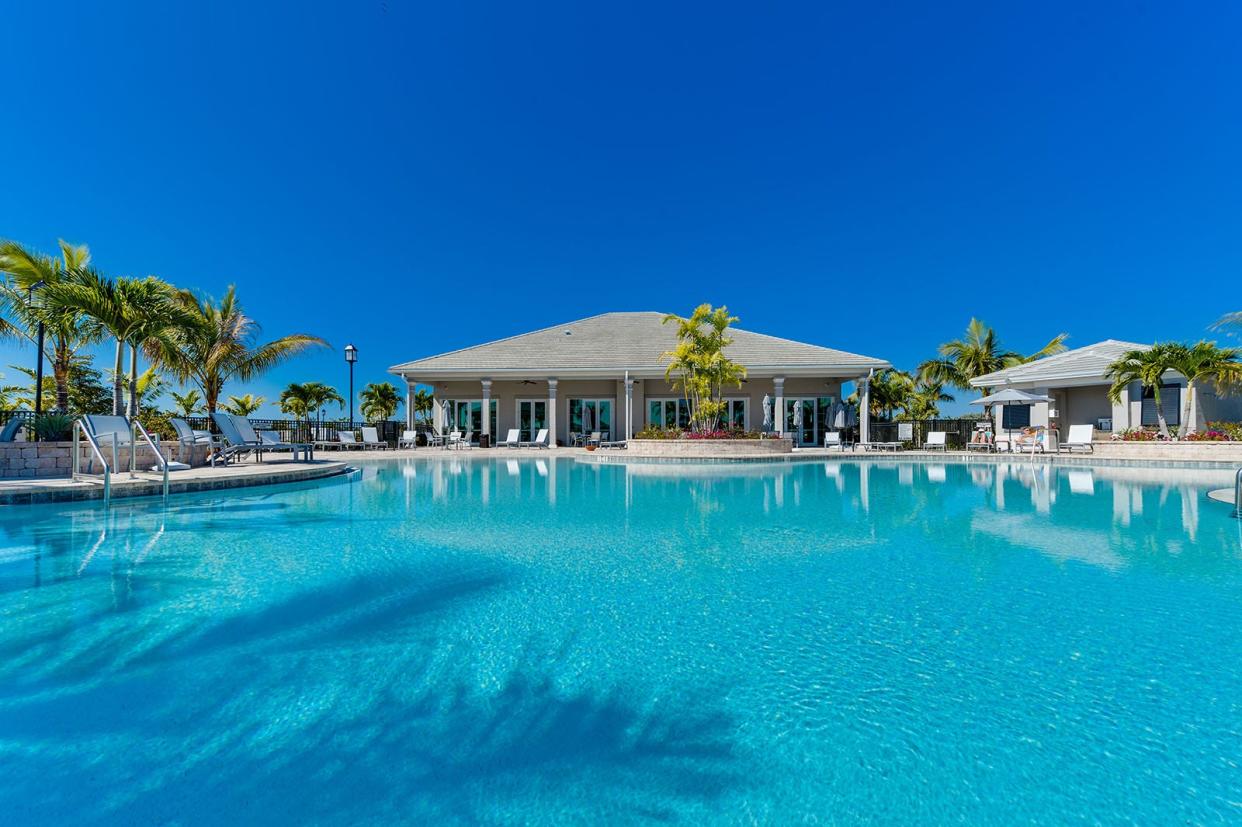 Sun and shade decks surround the Pool and are furnished with lounge and umbrella-shaded seating.