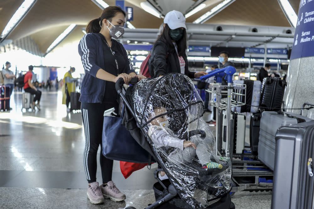 Travellers are pictured at the Kuala Lumpur International Airport in Sepang March 17, 2020. — Picture by Shafwan Zaidon