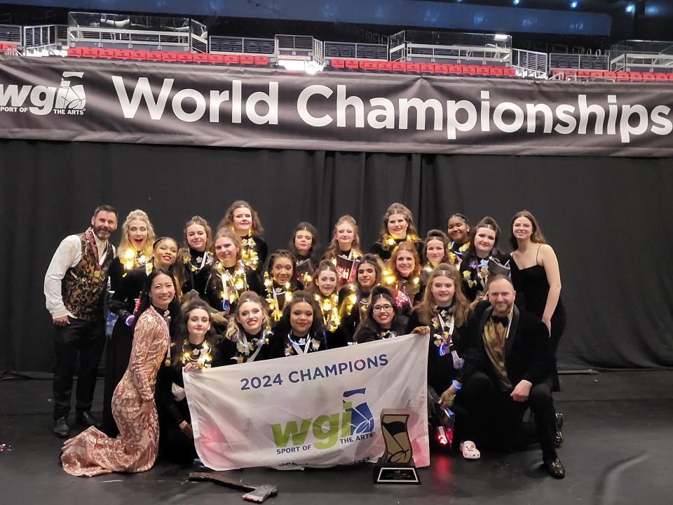 The Arlington High School winter guard poses after winning the scholastic "A" Class title at the Winter Guard International world championships in Ohio.