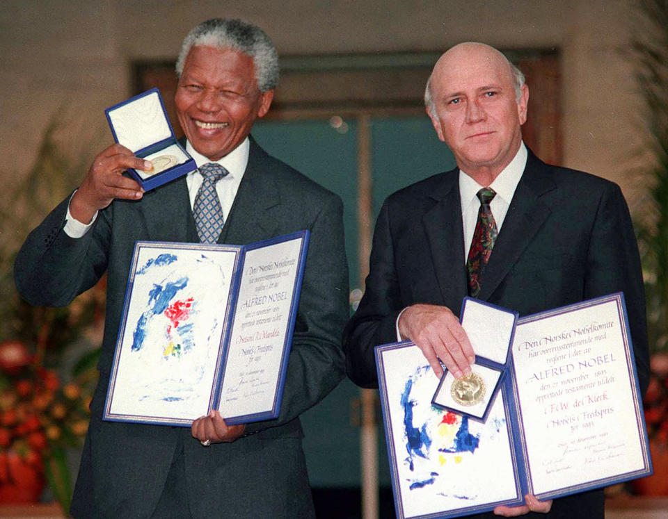 FILE - South African Deputy President F.W. de Klerk, right, and South African President Nelson Mandela pose with their Nobel Peace Prize Gold Medals and Diplomas in Oslo, Norway on Dec. 10, 1993. For working together to end apartheid, de Klerk and Mandela were together awarded the Nobel Peace Prize. (AP Photo/Jon Eeg, File)