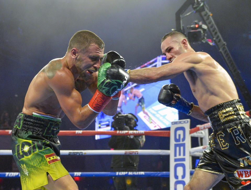 Jose Pedraz, right, lands a punch against Vasiliy Lomachenko in lightweight boxing match at Madison Square Garden, Saturday, Dec. 8, 2018, in New York. (AP Photo/Howard Simmons)