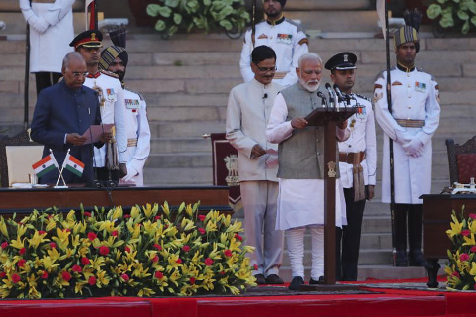 Indian President Ram Nath Kovind, left, administers oath to Narendra Modi, right, for a second term as India's prime minister during a swearing in ceremony at the presidential palace in New Delhi, India, Thursday, May 30, 2019. Modi was sworn in Thursday for a second term after an overwhelming election victory for his Hindu nationalist party in a country of 1.3 billion people seeking swift economic change. (AP Photo/Manish Swarup)