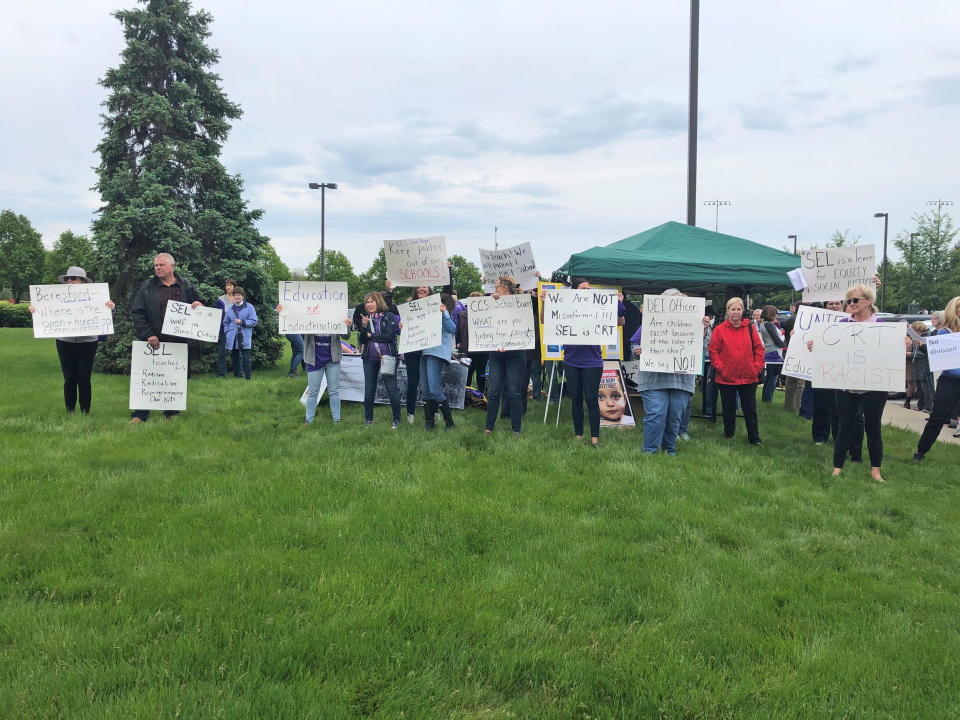 A crowd carrying signs protesting SEL gathers ahead of the Carmel Clay School Board meeting on May 17, 2021. (MJ Slaby  / IndyStar via USA Today Network)