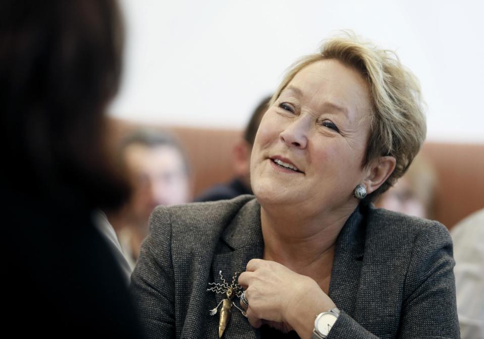 Parti Quebecois Pauline Marois listens to speeches at a campaign stop in Laval Quebec