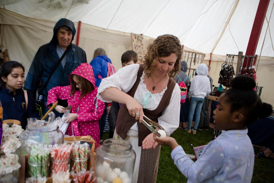 Emily Berry sells a student a primitive candy during the 50th annual Appalachian Festival in 2019.