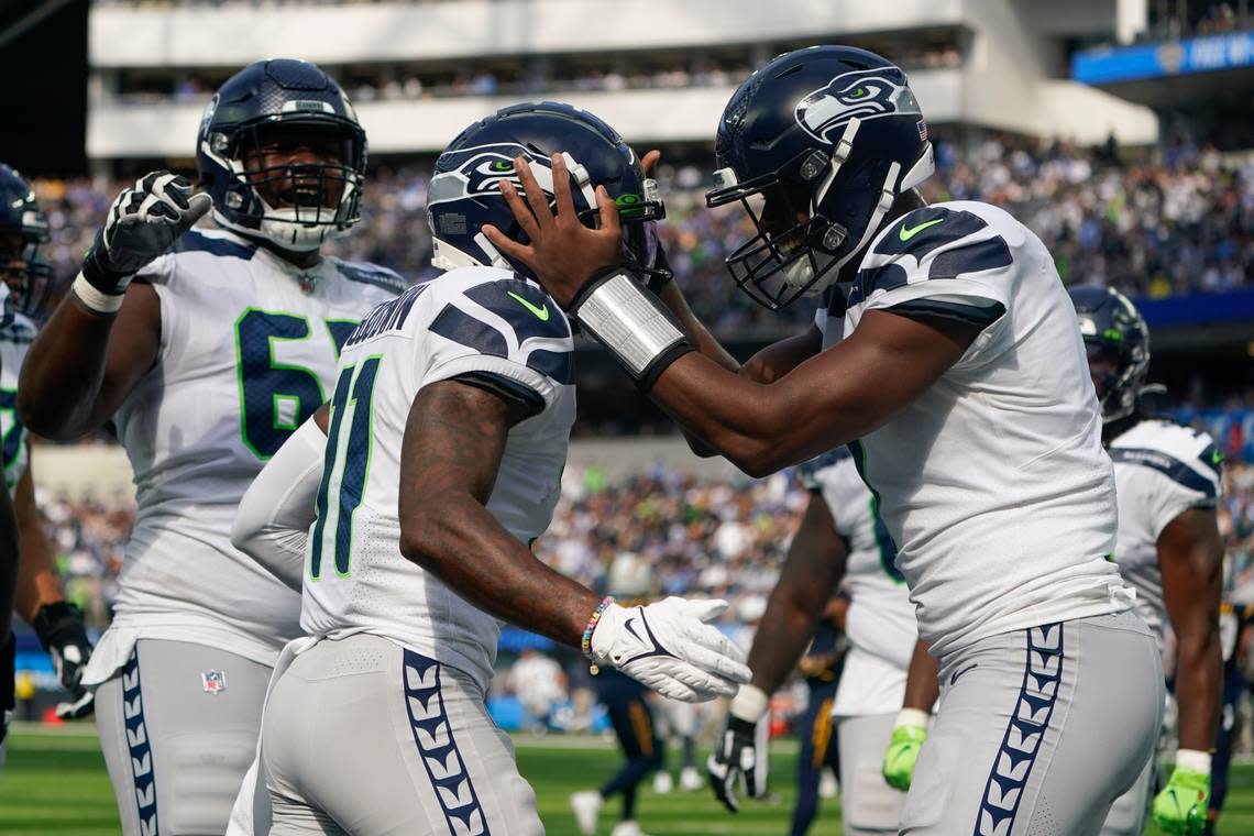 Seattle Seahawks wide receiver Marquise Goodwin (11) celebrates with quarterback Geno Smith, right, after scoring a touchdown during the first half of an NFL football game against the Los Angeles Chargers Sunday, Oct. 23, 2022, in Inglewood, Calif. (AP Photo/Marcio Jose Sanchez)