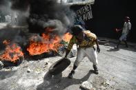 <p>Protesters barricade a street in the Port-au-Prince suburb of Petion-Ville on July 7, 2018, to protest against the increase in fuel prices. (Photo: Hector Retamal/AFP/Getty Images) </p>