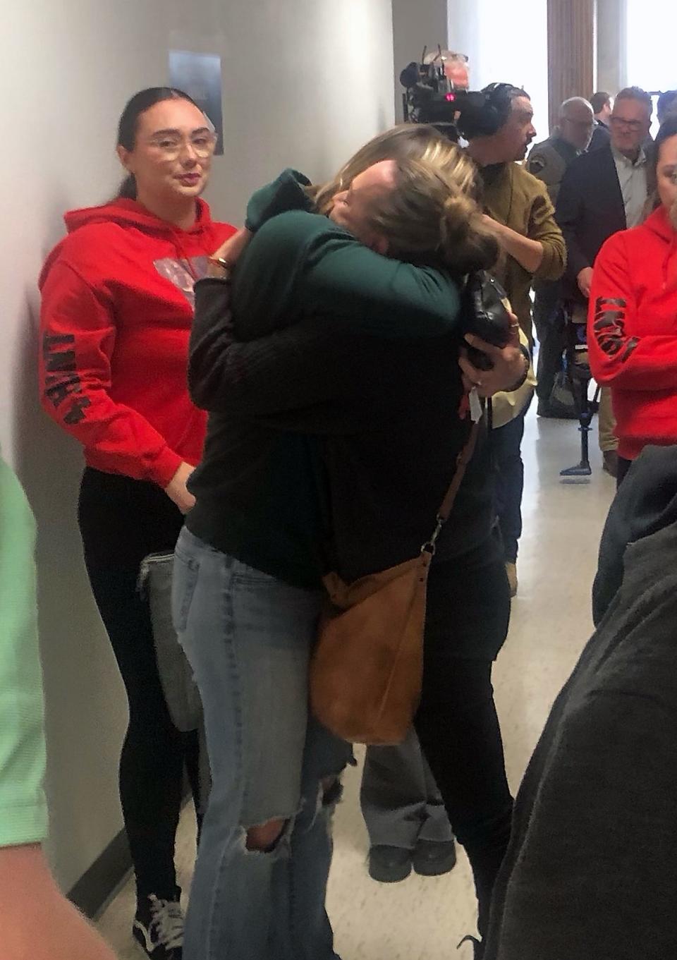 Carly Schaap, right, hugs family member Dallas Llamas after a guilty verdict was announced in Kitsap Superior Court for the three men accused of murdering four members of the Careaga family in 2017.