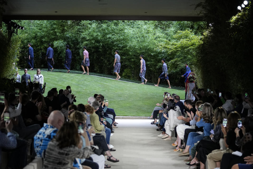 Models wear creations as part of the Giorgio Armani men's Spring Summer 2022 collection, in Milan, Italy, Monday, June 21, 2021. (AP Photo/Luca Bruno)