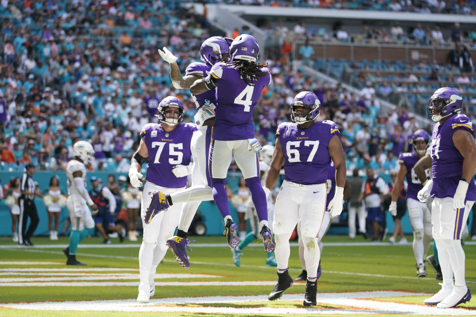 Minnesota Vikings tight end Irv Smith Jr. (84), top left, celebrates scoring a touchdown with teammates during the first half of an NFL football game against the Miami Dolphins, Sunday, Oct. 16, 2022, in Miami Gardens, Fla. (AP Photo/Lynne Sladky)