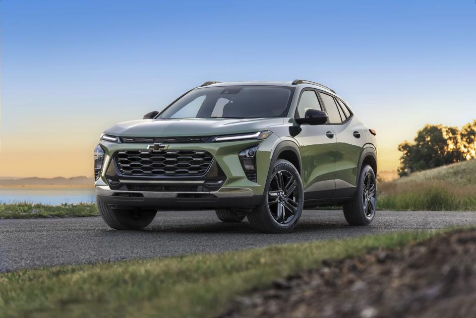 front 78 view of chevrolet trax activ in cacti green parked on a road in front of a lake pre production model shown actual production model may vary available in spring 2023 cacti green exterior color late availability