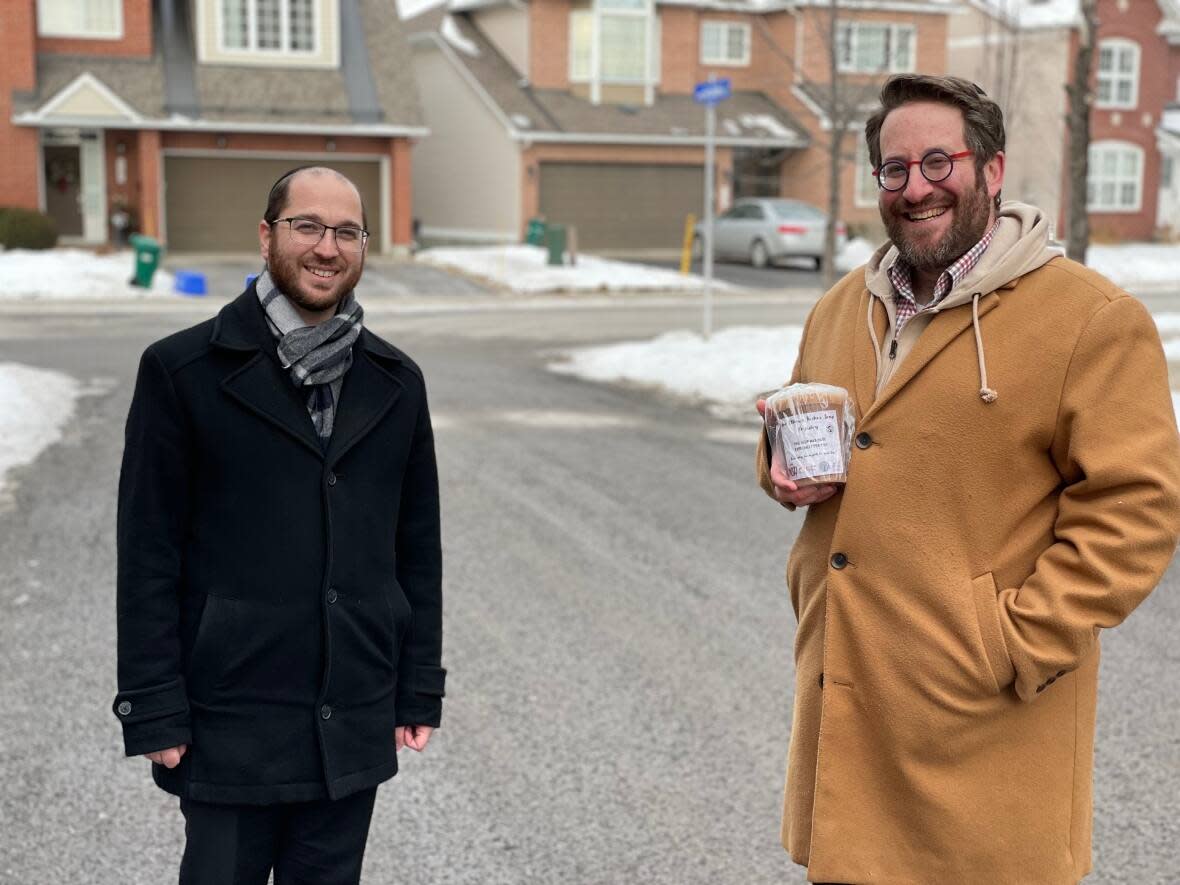 Rabbi Aryeh Kravetz, left, stands next to Rabbi Dave Rotenberg. Members of Ottawa's Jewish community have tried to make a difference during this latest wave of the pandemic by dropping off hot chicken soup. (Ryan Garland/CBC - image credit)