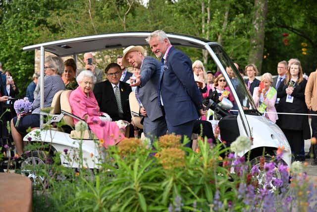 The Queen sitting in a buggy during a visit by members of the royal family to the RHS Chelsea Flower Show 