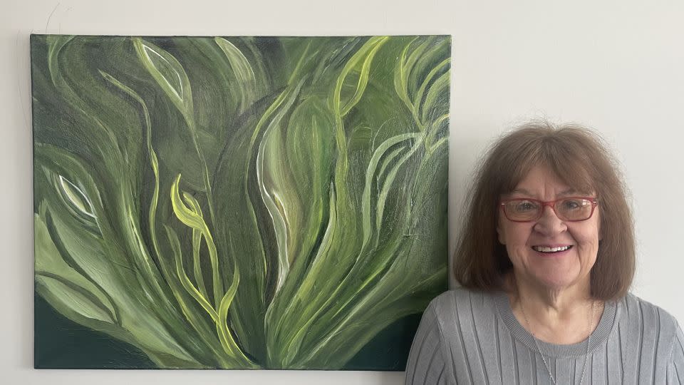 Diane Reiter poses with a painting she made in her home in the suburbs of Chicago. - Courtesy Diane Reiter