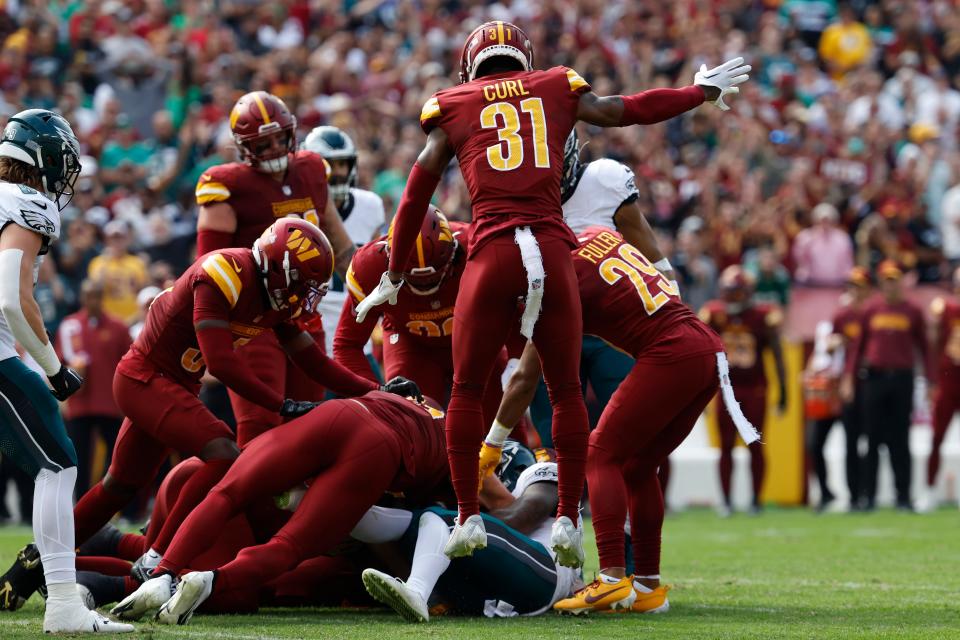 Commanders safety Kamren Curl celebrates after fumble recovery against the Eagles during the second quarter at FedExField in Landover, Md., on Oct. 29, 2023.