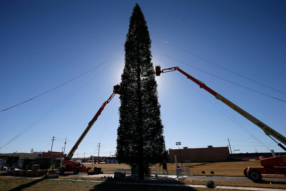 In this November 2021 photo, workers decorate a 140-foot-tall fresh-cut Christmas tree for display as part of "The One," a Christmas event that begins with a tree-lighting ceremony.
(Photo: BRYAN TERRY/THE OKLAHOMAN)