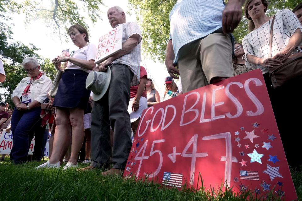 People bow their heads during a prayer during a Prayer Vigil for America Sunday, July 14, 2024 at Zeidler Union Square in Milwaukee, Wisconsin. The park is located five blocks from Fiserv Forum, site of the Republican National Convention that starts Monday.

Mark Hoffman/Milwaukee Journal Sentinel (Via OlyDrop)