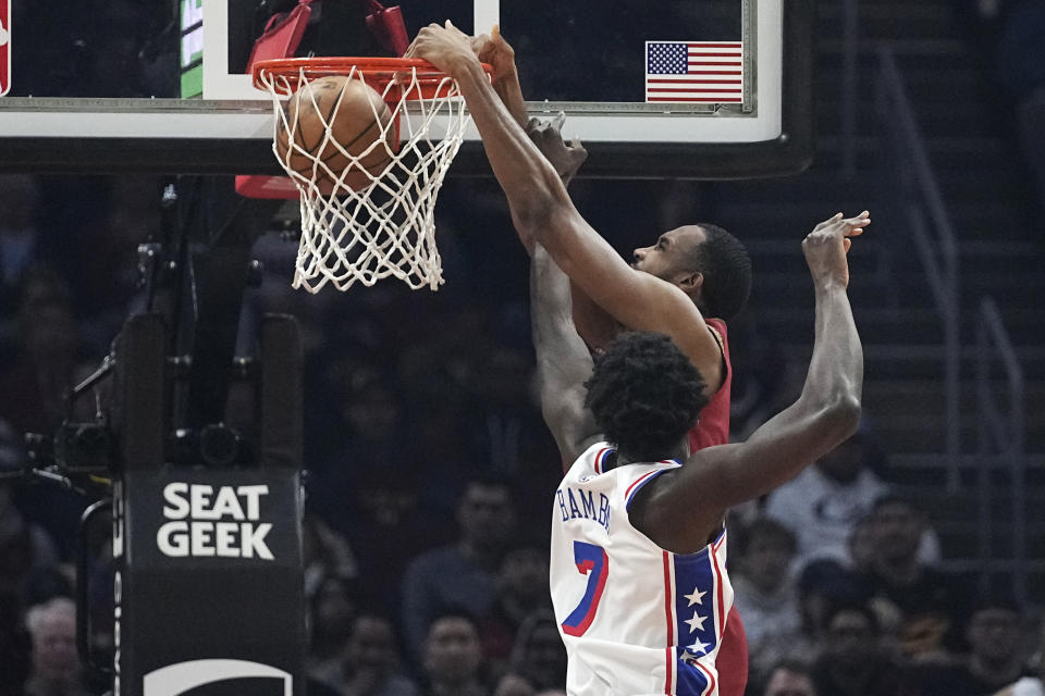 Cleveland Cavaliers forward Evan Mobley, top, dunks in front of Philadelphia 76ers center Mo Bamba (7) in the first half of an NBA basketball game, Monday, Feb. 12, 2024, in Cleveland. (AP Photo/Sue Ogrocki)