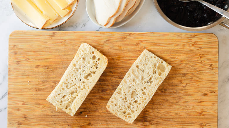 Two ciabatta halves on cutting board