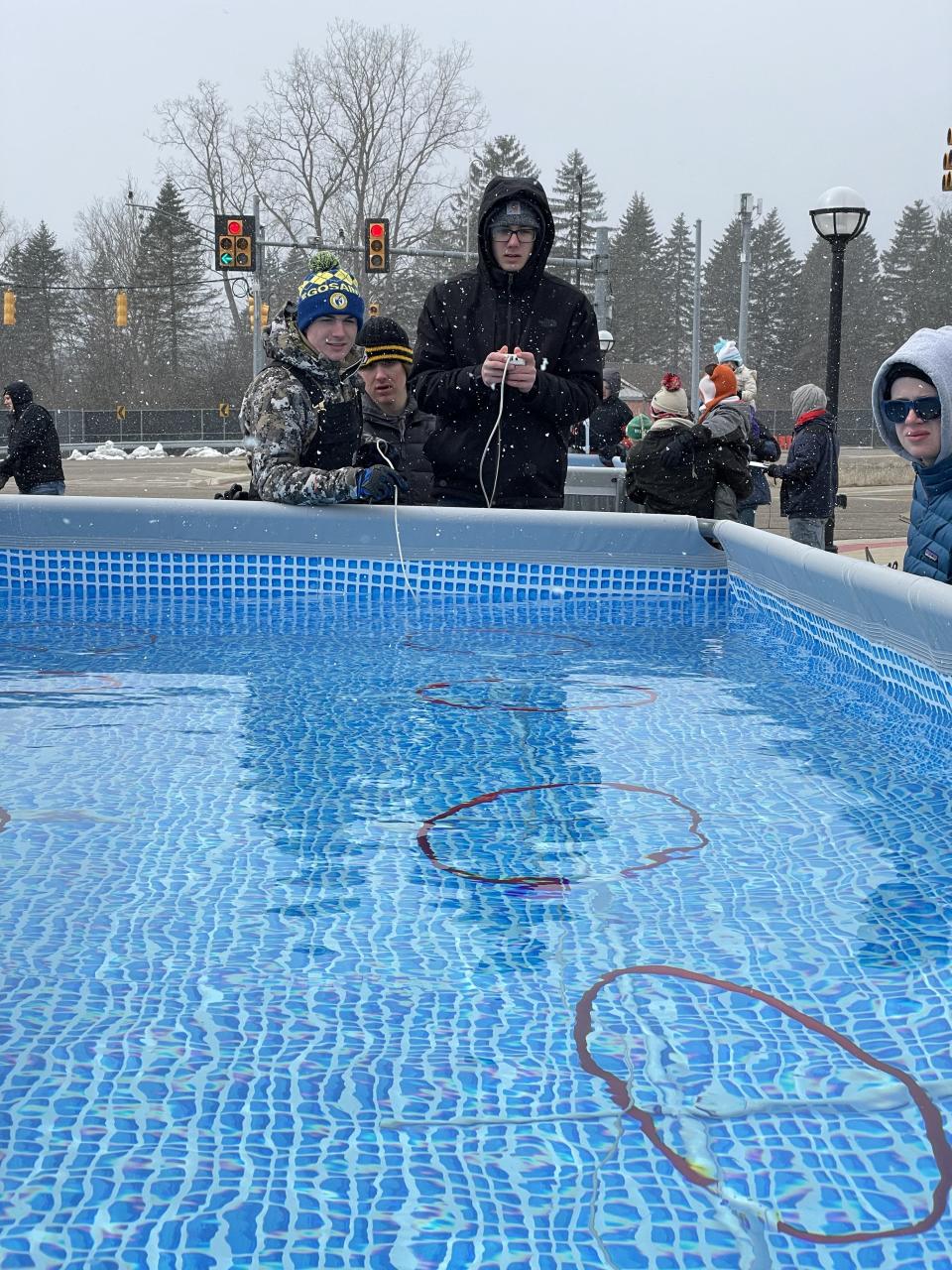 Team Bazooka Space Sharks from Clinton High School — from left, Zak Shadley, Jacob Gilson and Caden Arntz — drive an underwater robot through the Obstacle Hoops Course during the Michigan Regional SeaPerch Underwater Robotics Competition March 18 at the University of Michigan in Ann Arbor.