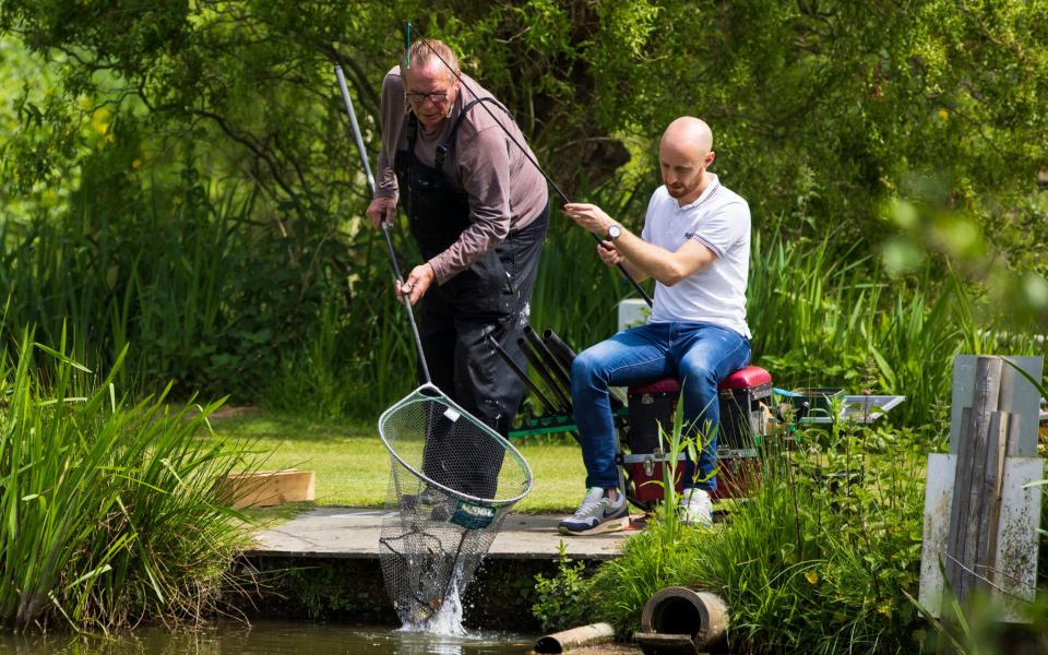 Bobby George teaches Telegraph reporter Ben Bloom to fish on one of his lakes - JAMIE LORRIMAN