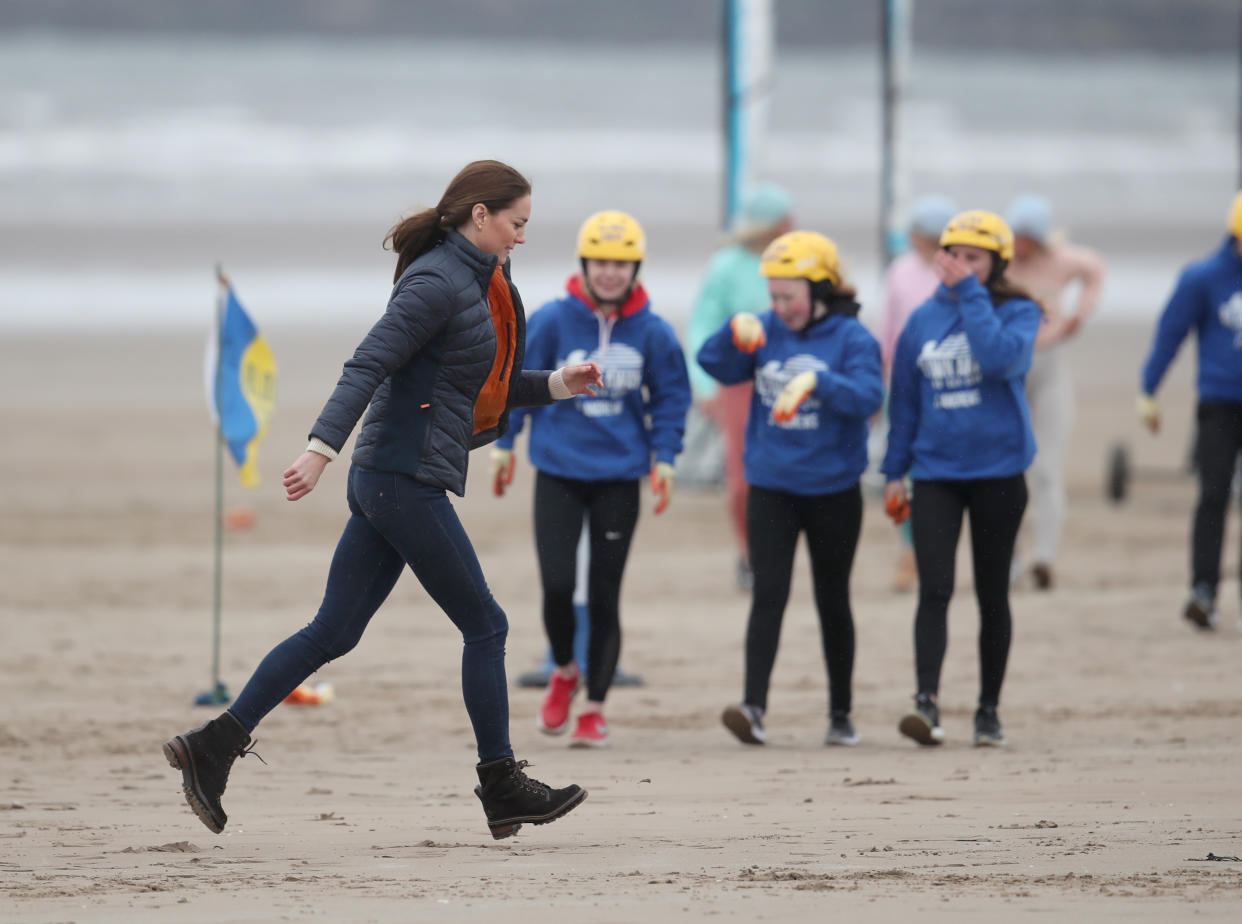 EMBARGOED UNTIL 1050 WEDNESDAY MAY 26 The Duchess of Cambridge with a group of young carers land yachting on the beach at St Andrews. Picture date: Wednesday May 26, 2021.