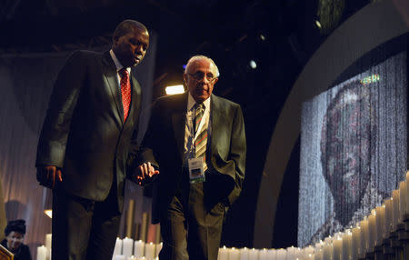 FILE PHOTO: Anti-apartheid activist and close friend of former South African President Nelson Mandela, Ahmed Kathrada (R), arrives for the funeral ceremony of Mandela in Qunu December 15, 2013. REUTERS/Odd Andersen/Pool/File Photo