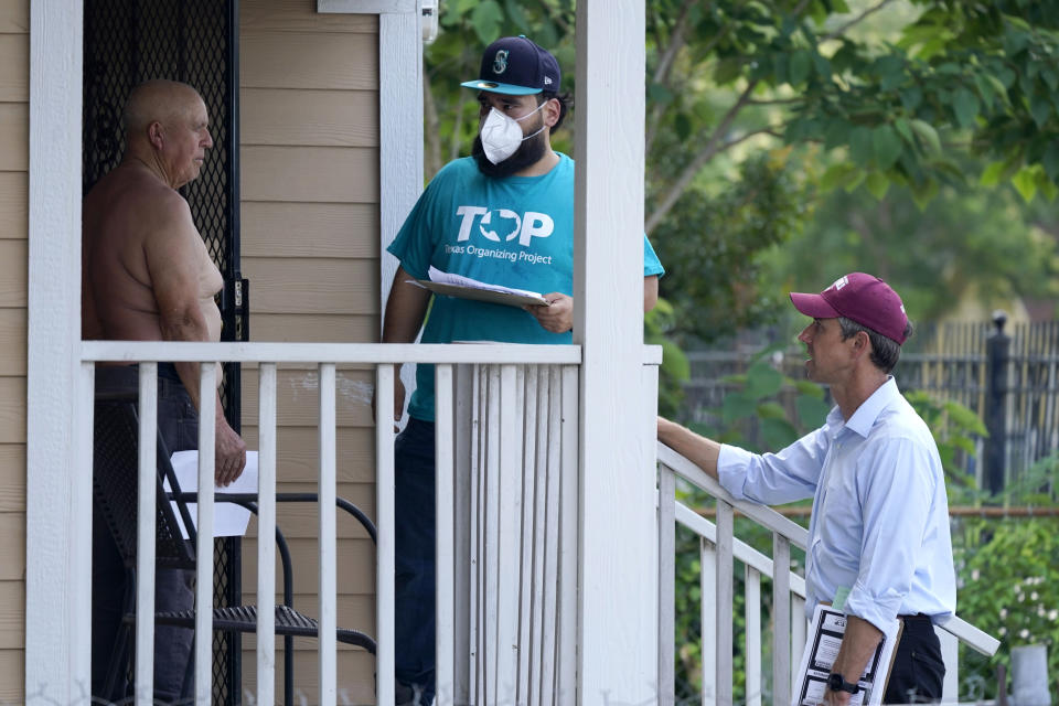 West Dallas resident Julian Campos, left, listens to Beto O'Rourke, right, along with Texas Organizing Project volunteer David Villalobos during a neighborhood canvassing Wednesday, June 9, 2021. The former congressman and senatorial candidate is driving an effort to gather voter support to stop Texas' SB7 voting legislation. As politicians from Austin to Washington battle over how to run elections, many voters are disconnected from the fight. While both sides have a passionate base of voters intensely dialed in on the issue, a disengaged middle is baffled at the attention. (AP Photo/LM Otero)