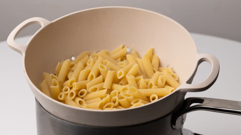 penne pasta in a colander 