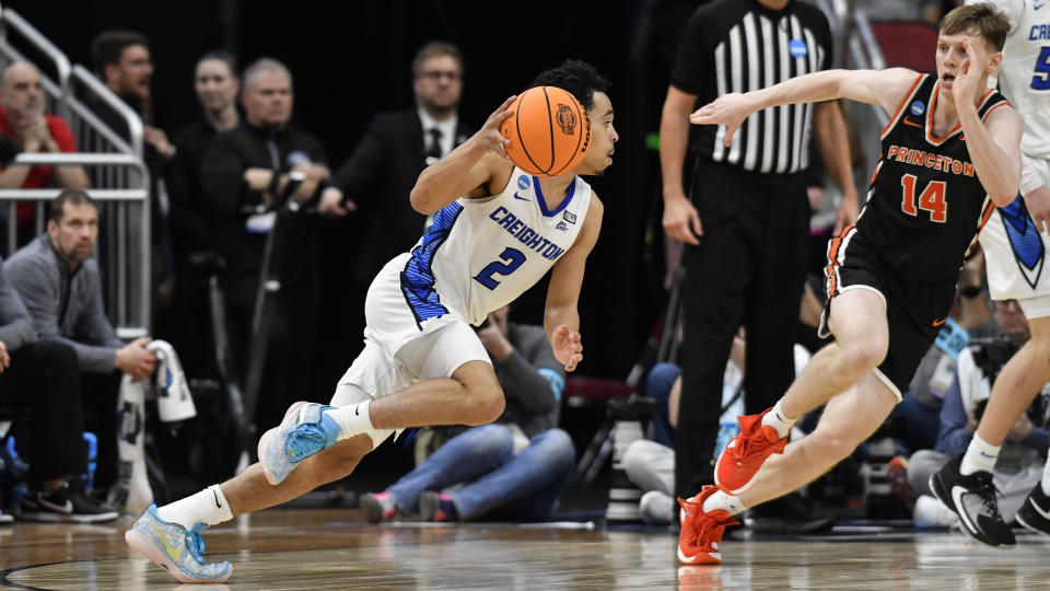 Creighton guard Ryan Nembhard (2) moves the ball against Princeton guard Matt Allocco (14) in the second half of a Sweet 16 round college basketball game in the South Regional of the NCAA Tournament, Friday, March 24, 2023, in Louisville, Ky. (AP Photo/Timothy D. Easley)