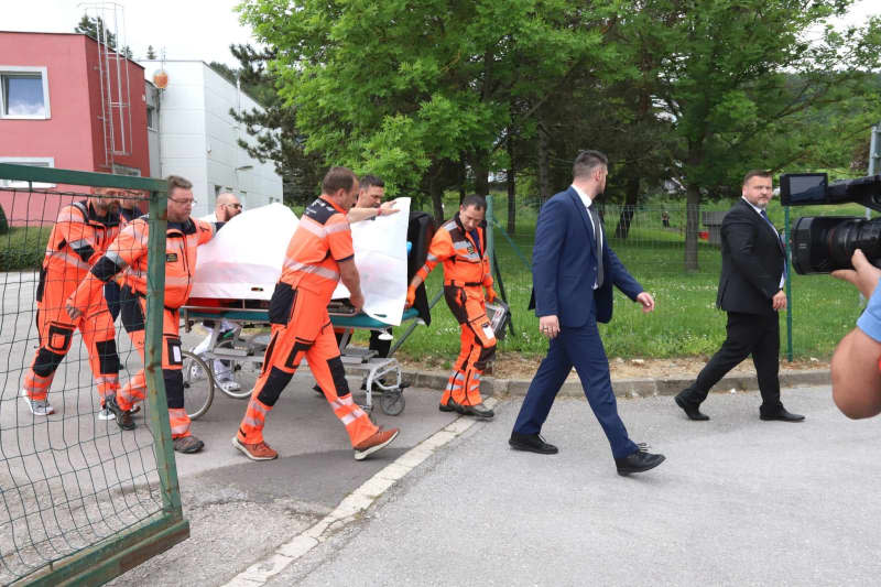 Rescue workers carry the shot and injured Slovakian Prime Minister Robert Fico on a stretcher to hospital. Jan Kroslák/TASR/dpa