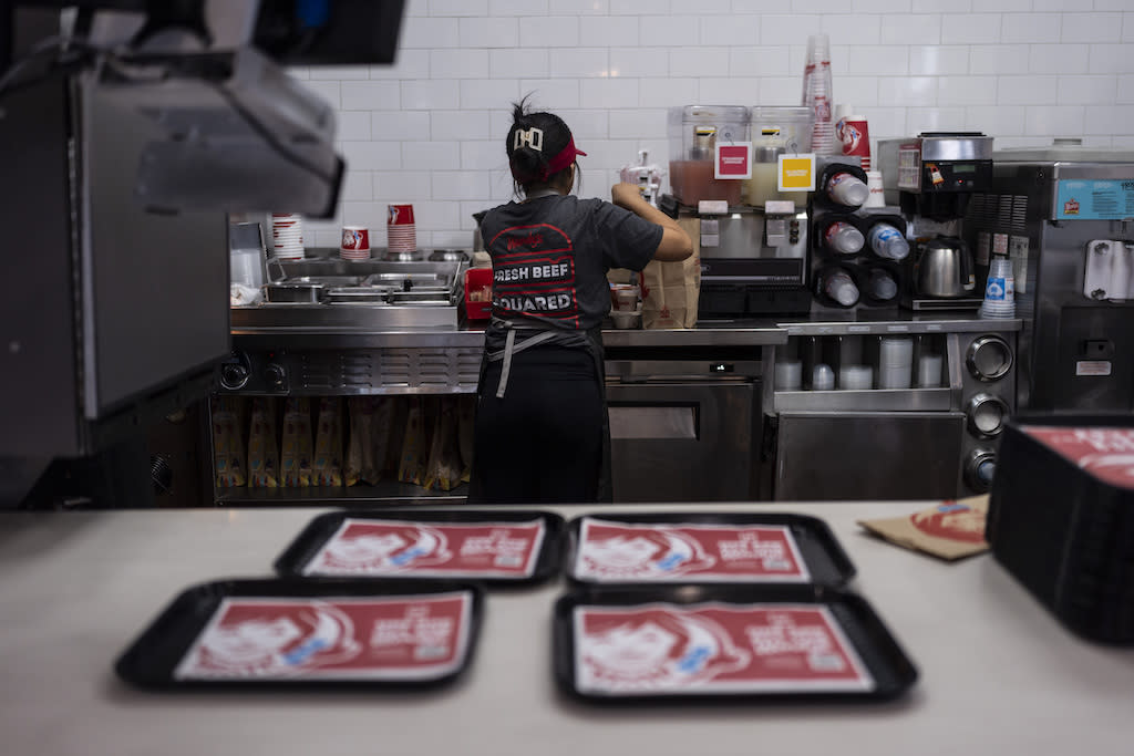 A worker in the kitchen of a fast-food restaurant..