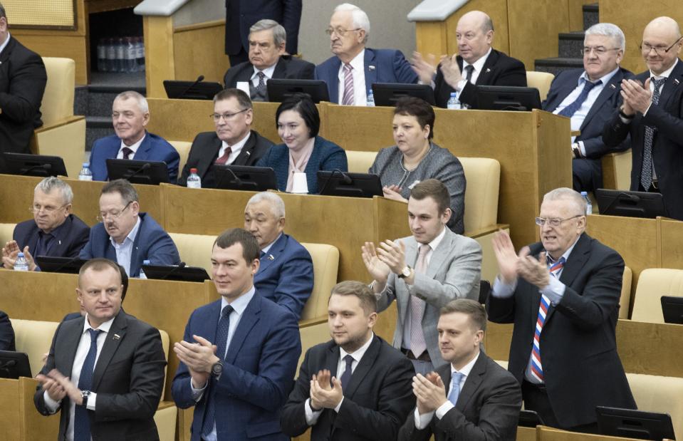 Russian lawmakers applauds after voting for Russian constitutional amendments during a session at the Russian State Duma, the Lower House of the Russian Parliament in Moscow, Russia, Thursday, Jan. 23, 2020. Kremlin-controlled lower house of parliament, the State Duma, unanimously voted for constitutional amendments on Thursday, widely seen as President Vladimir Putin's strategy to stay in power well past the end of his term in 2024. (AP Photo/Alexander Zemlianichenko)