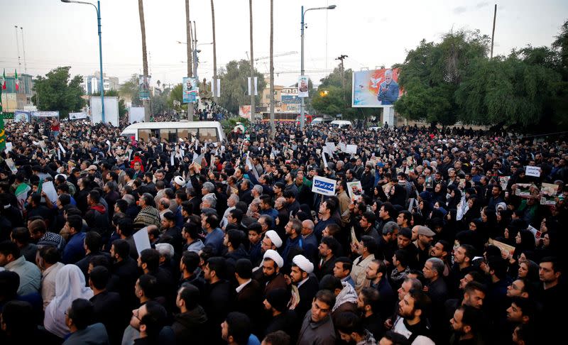 People attend a funeral procession for Soleimani and al-Muhandis, in Ahvaz