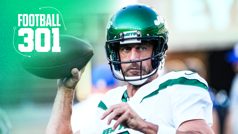 New York Jets QB Aaron Rodgers warms up on the sidelines before a game.