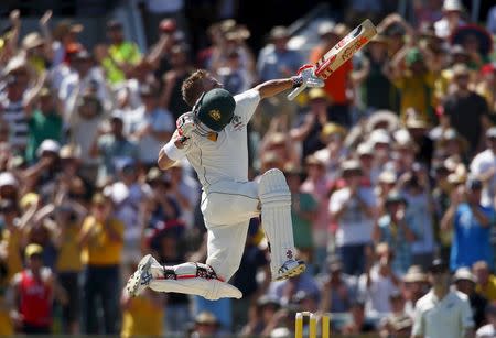 Australia's David Warner celebrates reaching his century during the first day of the second cricket test match against New Zealand at the WACA ground in Perth, Western Australia, November 13, 2015. REUTERS/David Gray