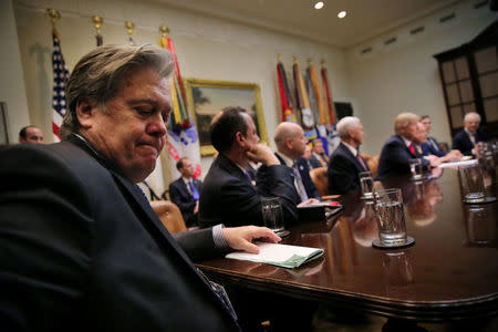 FILE PHOTO: White House Chief Strategist Stephen Bannon (L) attends a meeting between U.S. President Donald Trump and congressional leaders to discuss trade deals at the at the Roosevelt room of the White House in Washington, U.S., February 2, 2017. REUTERS/Carlos Barria/File Photo