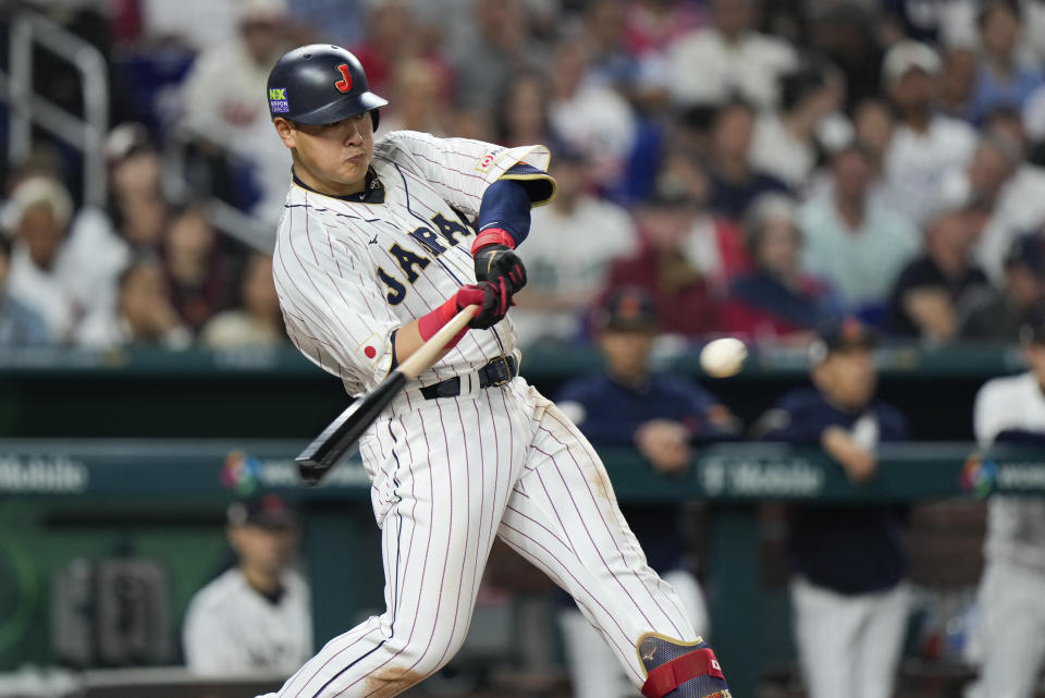 Japan's Kazuma Okamoto (25) hits a home run during fourth inning of a World Baseball Classic championship game against the United States, Tuesday, March 21, 2023, in Miami. (AP Photo/Wilfredo Lee)