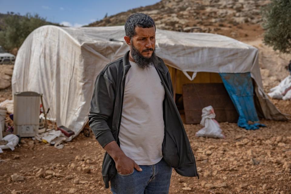 Ali Arrara, 35, by a tent in an olive grove where his family is now camping (Bel Trew/The Independent)