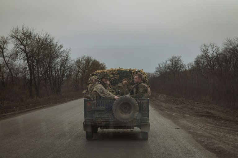 Des soldats ukrainiens à l'arrière d'un véhicule militaire sur une route près de Tchassiv Iar, dans la région de Donetsk, le 2 avril 2024 (Roman PILIPEY)